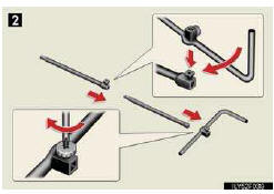 Remove the spare tire carrier lid using a flathead screwdriver.