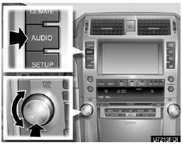“AUDIO”: Push this button to display touch−screen buttons for audio system